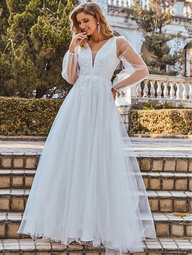 Close-up of the lace and tulle details on a white A-line wedding dress.
