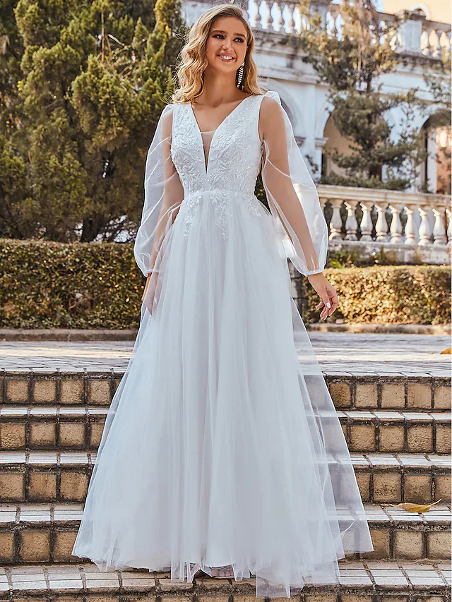 Back view of a white A-line wedding dress with a flowing floor-length skirt.