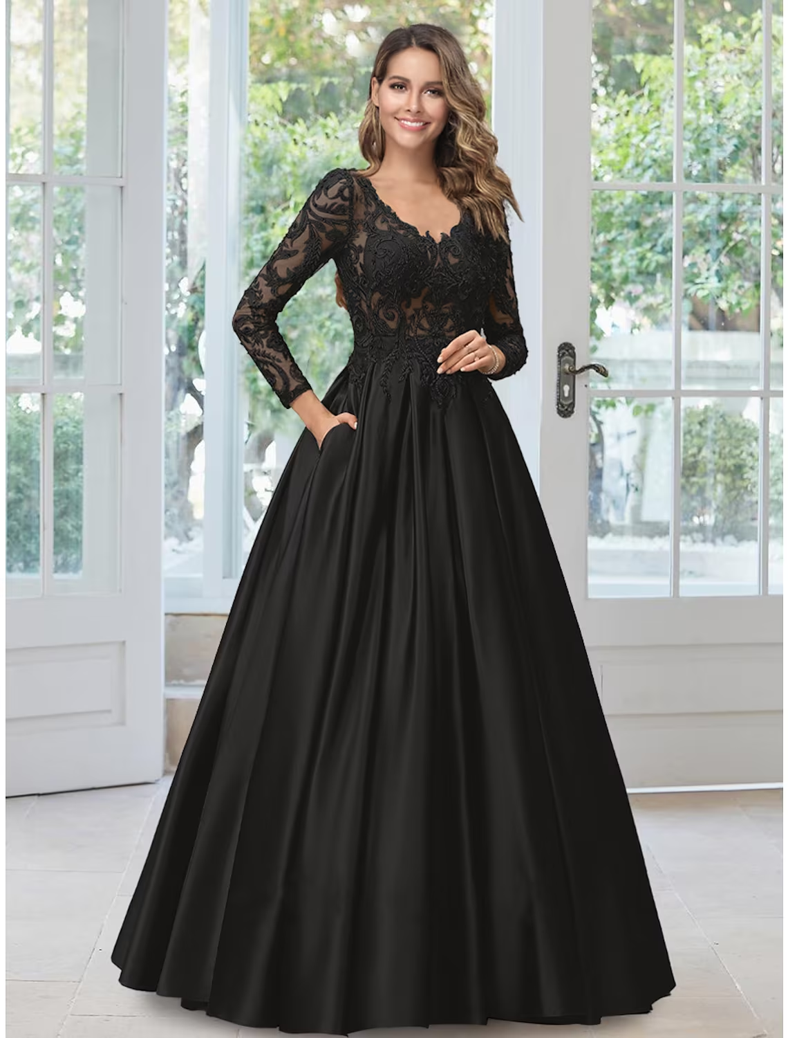 Elegant black A-line evening gown with V-neck and long sleeves, featuring lace appliques.