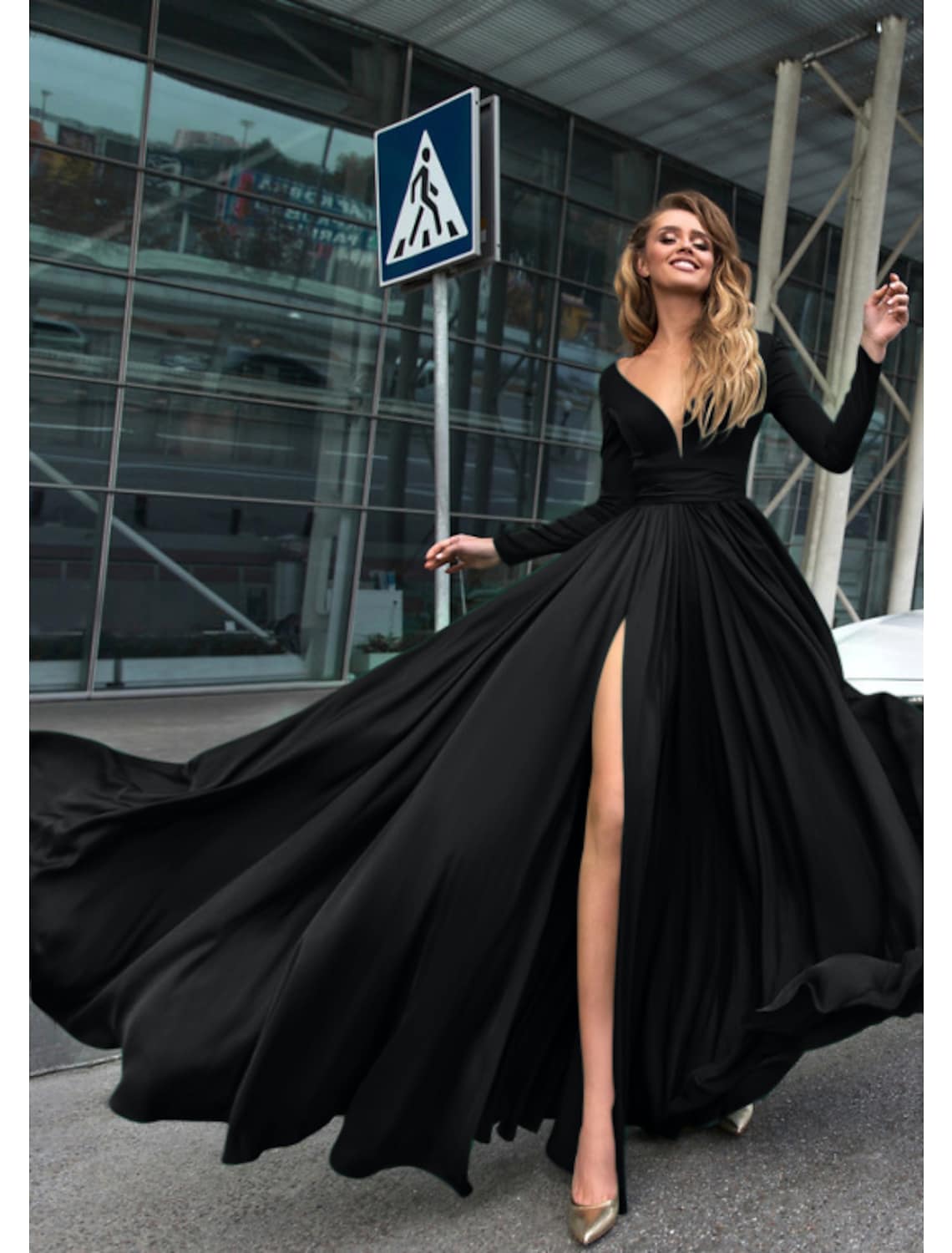 Woman wearing an elegant A-line V-neck long sleeve chiffon evening gown.