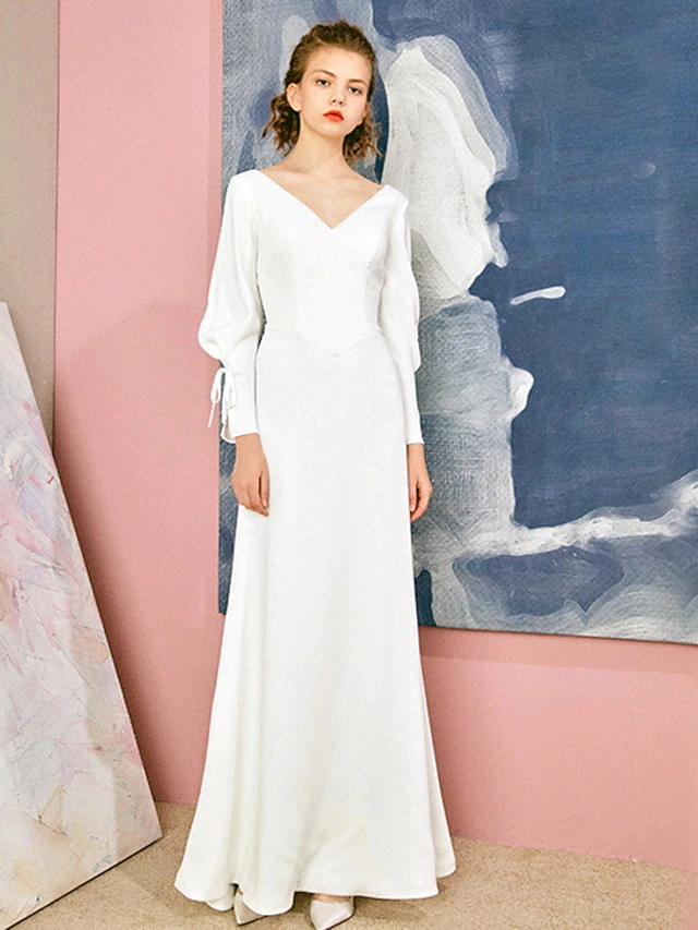 Elegant A-Line V-neck long sleeve chiffon wedding dress with bows.
