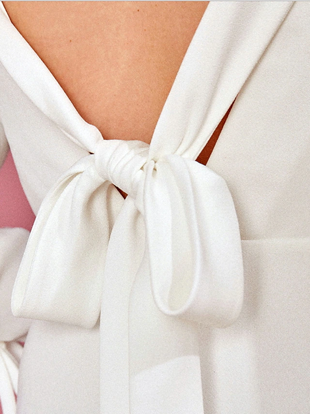 Full length view of a simple vintage A-Line wedding dress.