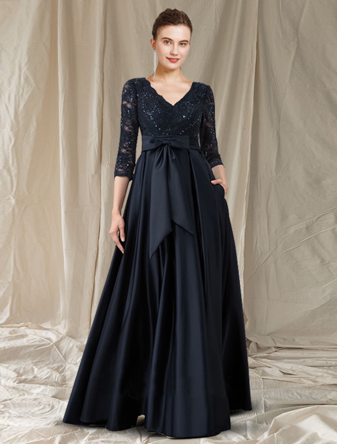 Elegant A-line lace evening gown with V-neck and long sleeves.