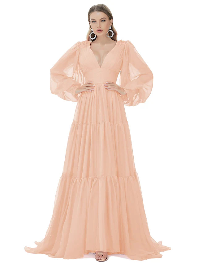 Woman in an A-line V-neck long sleeve ruched chiffon evening gown with a sweep train.