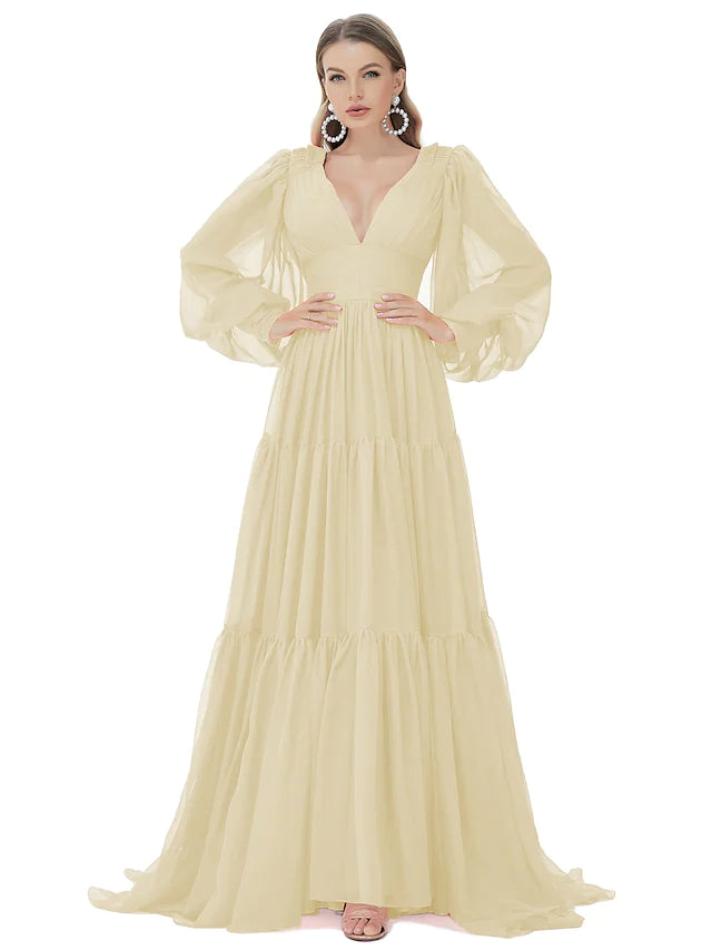 Side view of a woman in an A-line V-neck long sleeve ruched chiffon evening gown.
