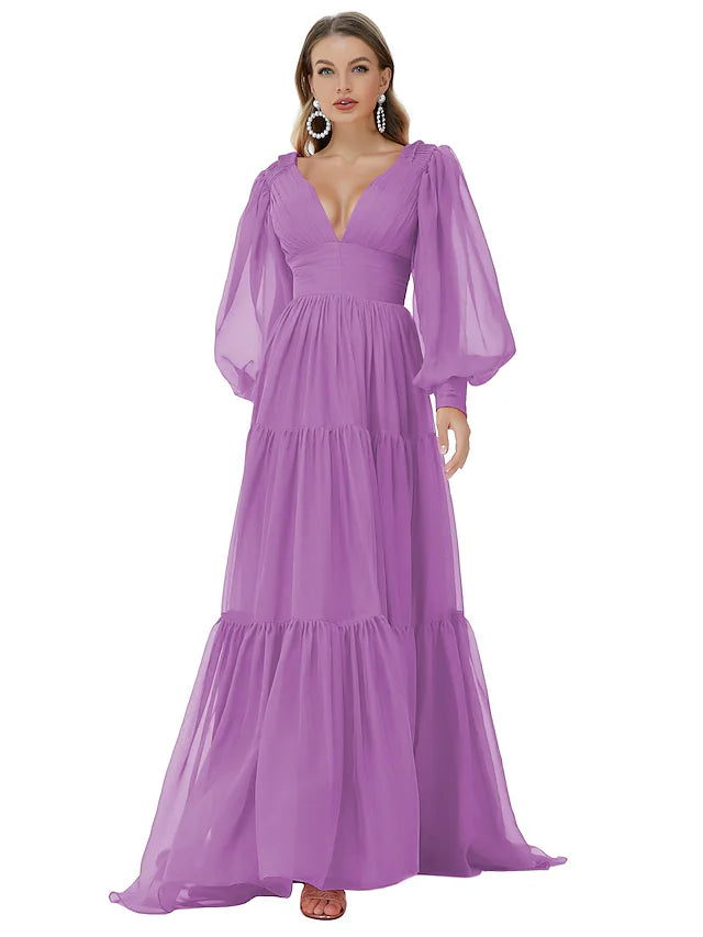 Back view of a woman in an A-line V-neck long sleeve ruched chiffon evening gown with a sweep train.
