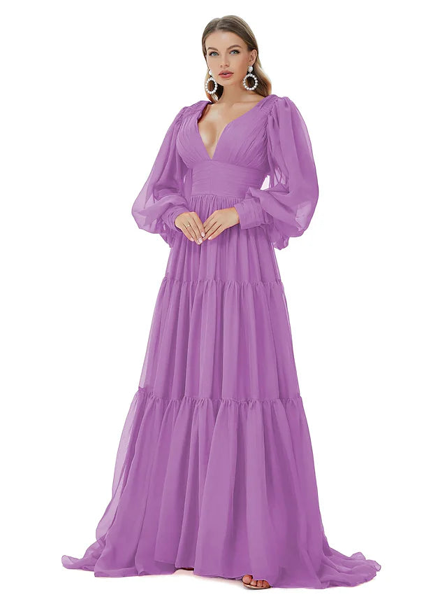 Woman posing in an A-line V-neck long sleeve ruched chiffon evening gown.