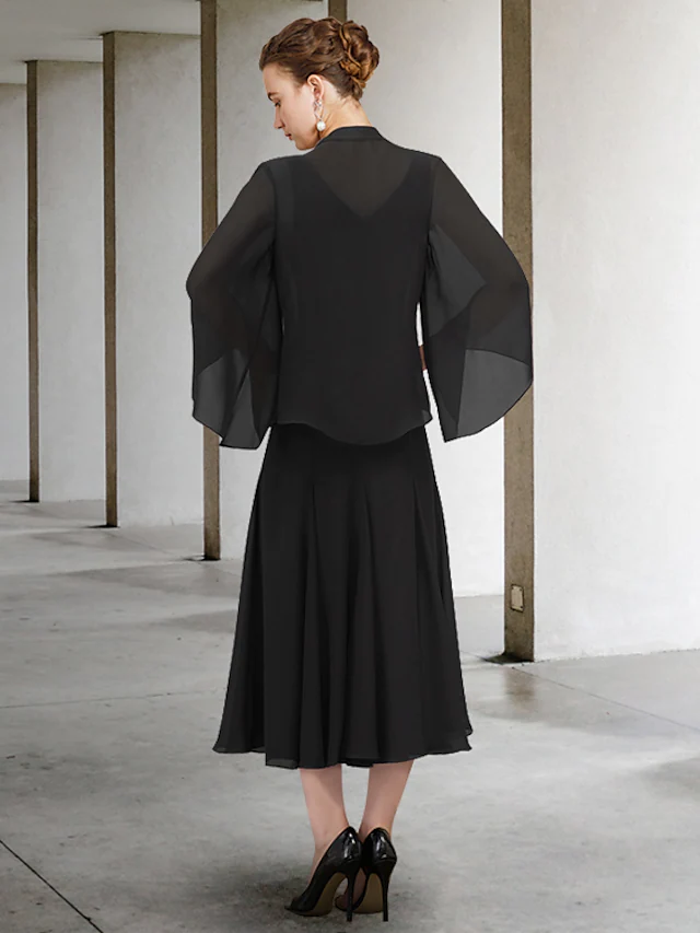 Full view of the tea-length chiffon mother of the bride dress with delicate beading.
