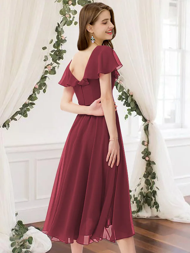 Back view of a knee-length ruched chiffon bridesmaid dress.