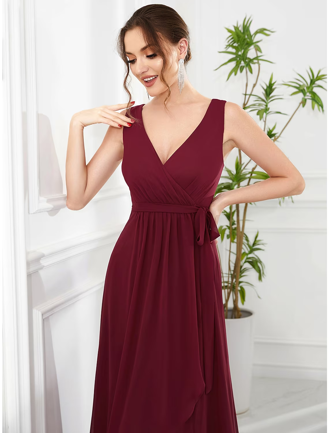 Model wearing a green A-line V-neck sleeveless dress with ruffles.