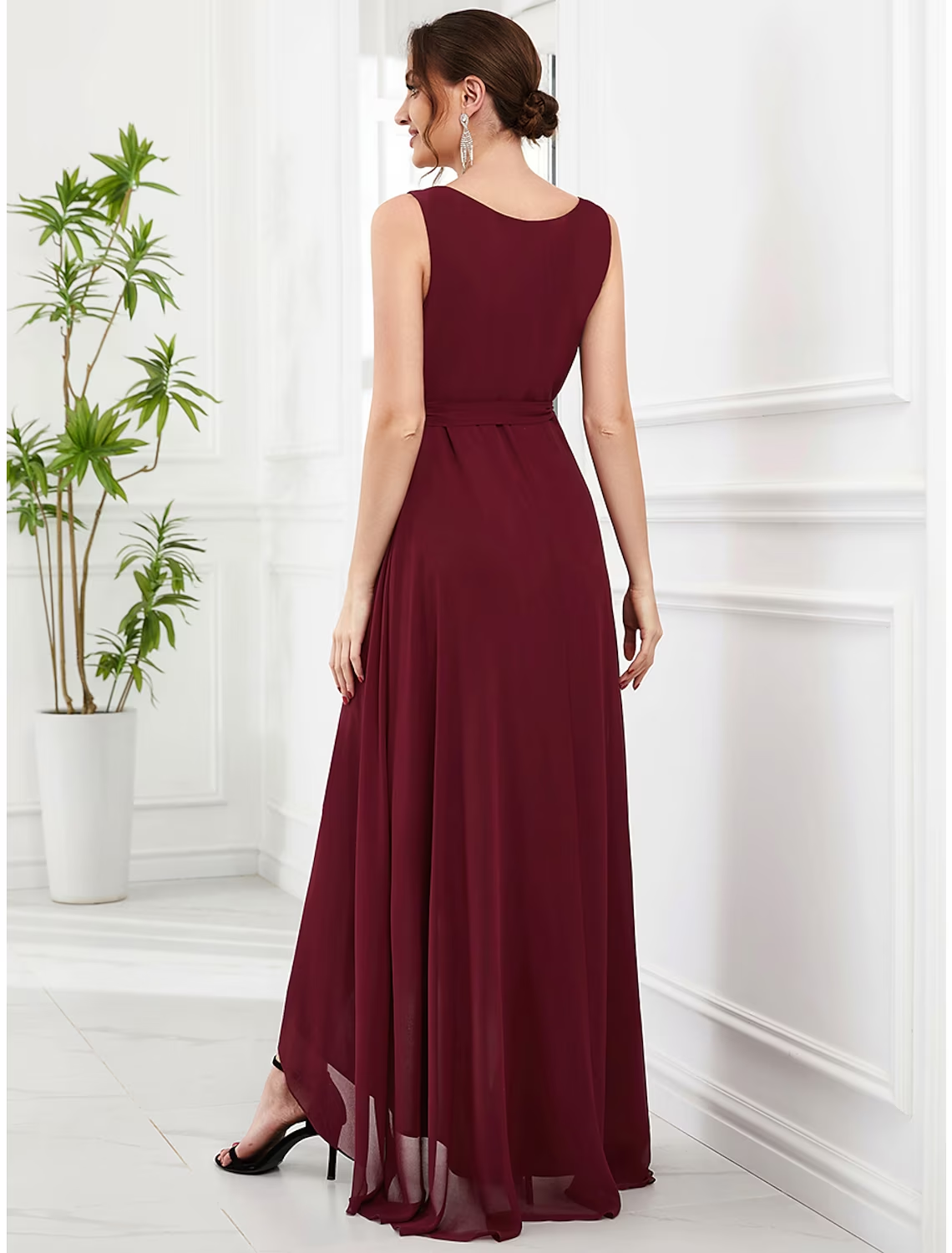 Model wearing a purple A-line chiffon dress, showcasing the strappy back.