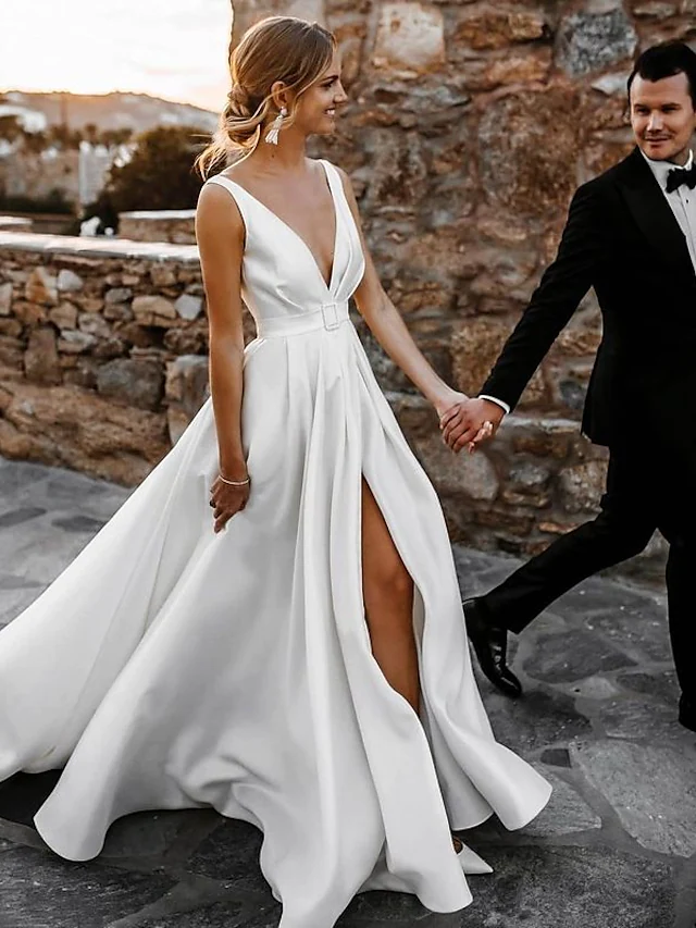 Side view of the A-line satin wedding dress, showcasing the split front.