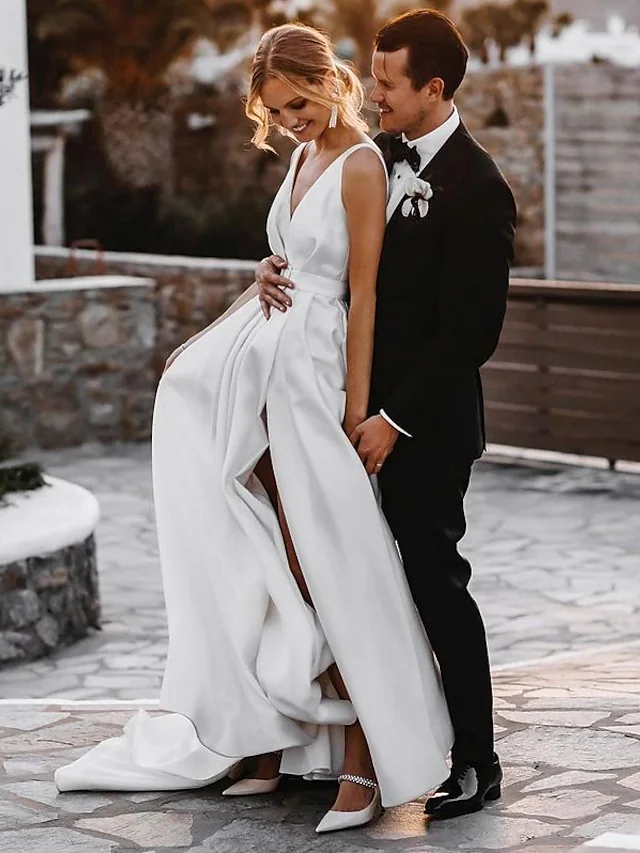 Full length view of the elegant A-line satin wedding gown.