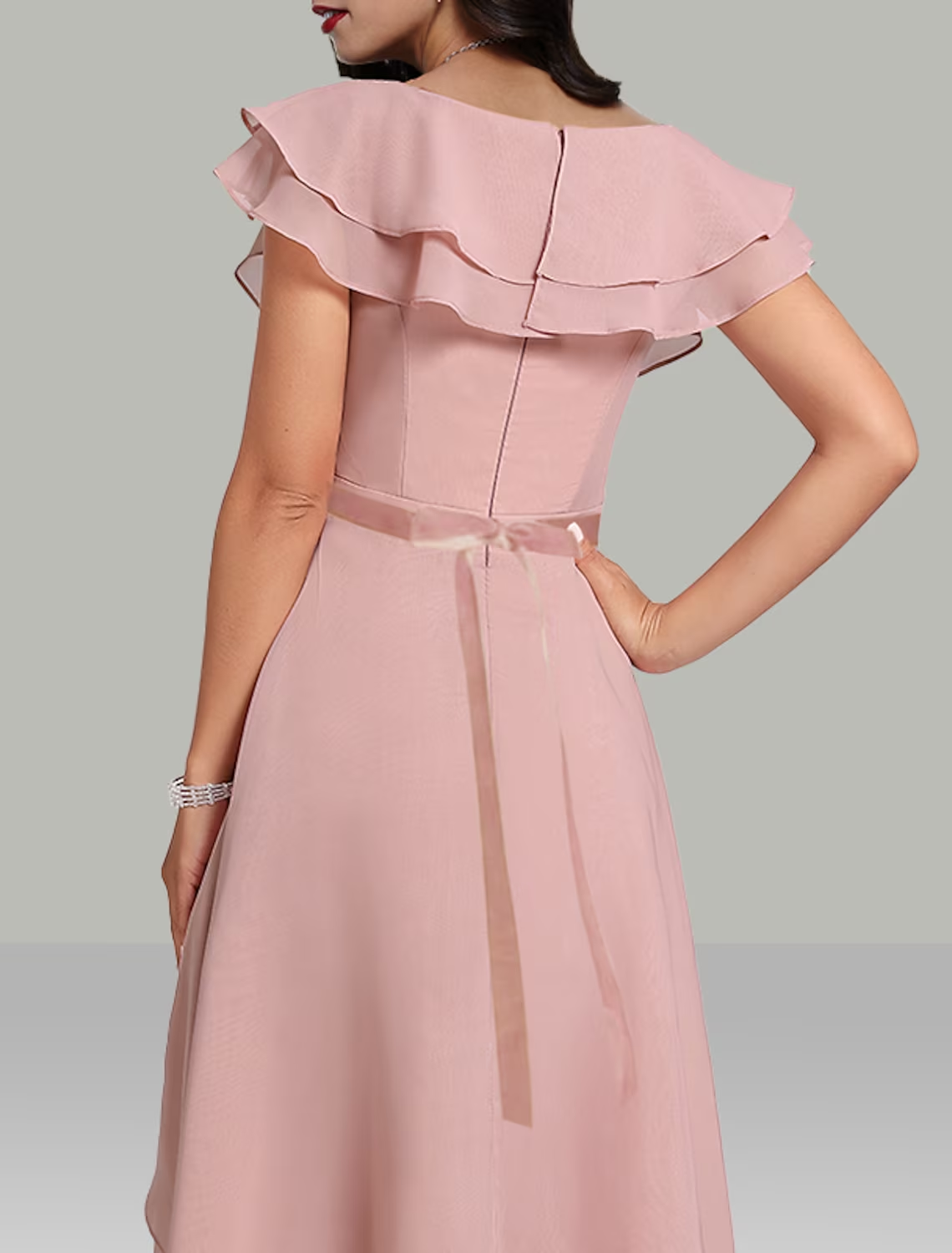 Close-up of the V-neckline and short sleeves on the beaded chiffon dress.