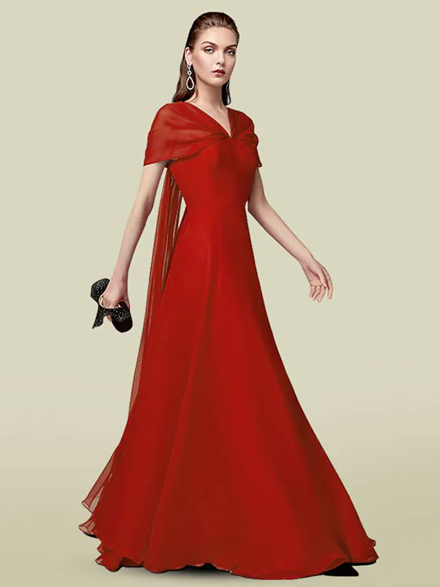 Woman wearing an elegant A-line V-neck short-sleeve chiffon dress with pleats, full length.