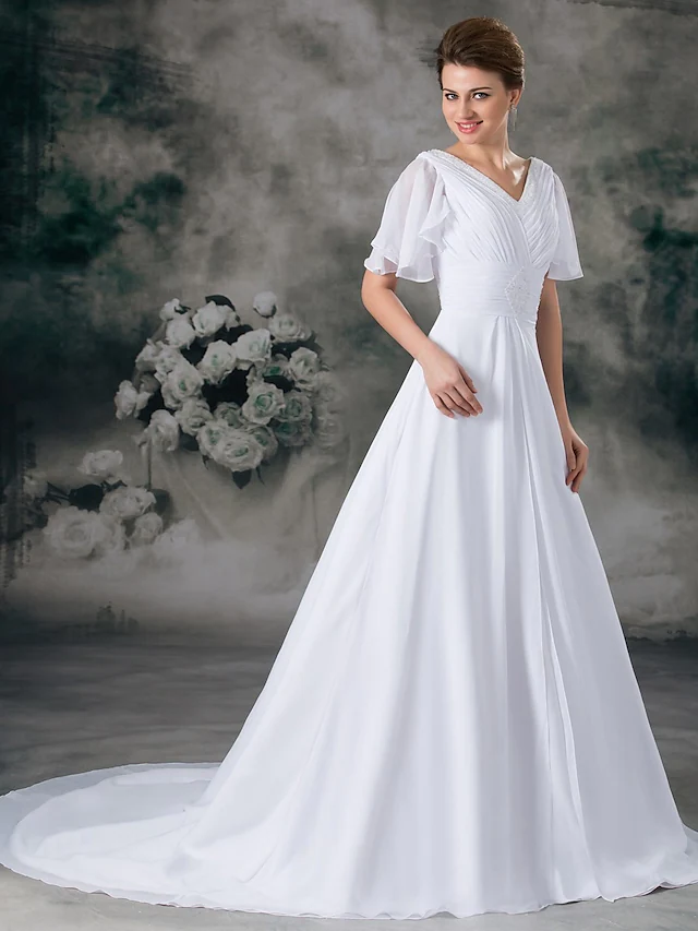 Back view of A-line wedding dress showing chapel train and ruched details.