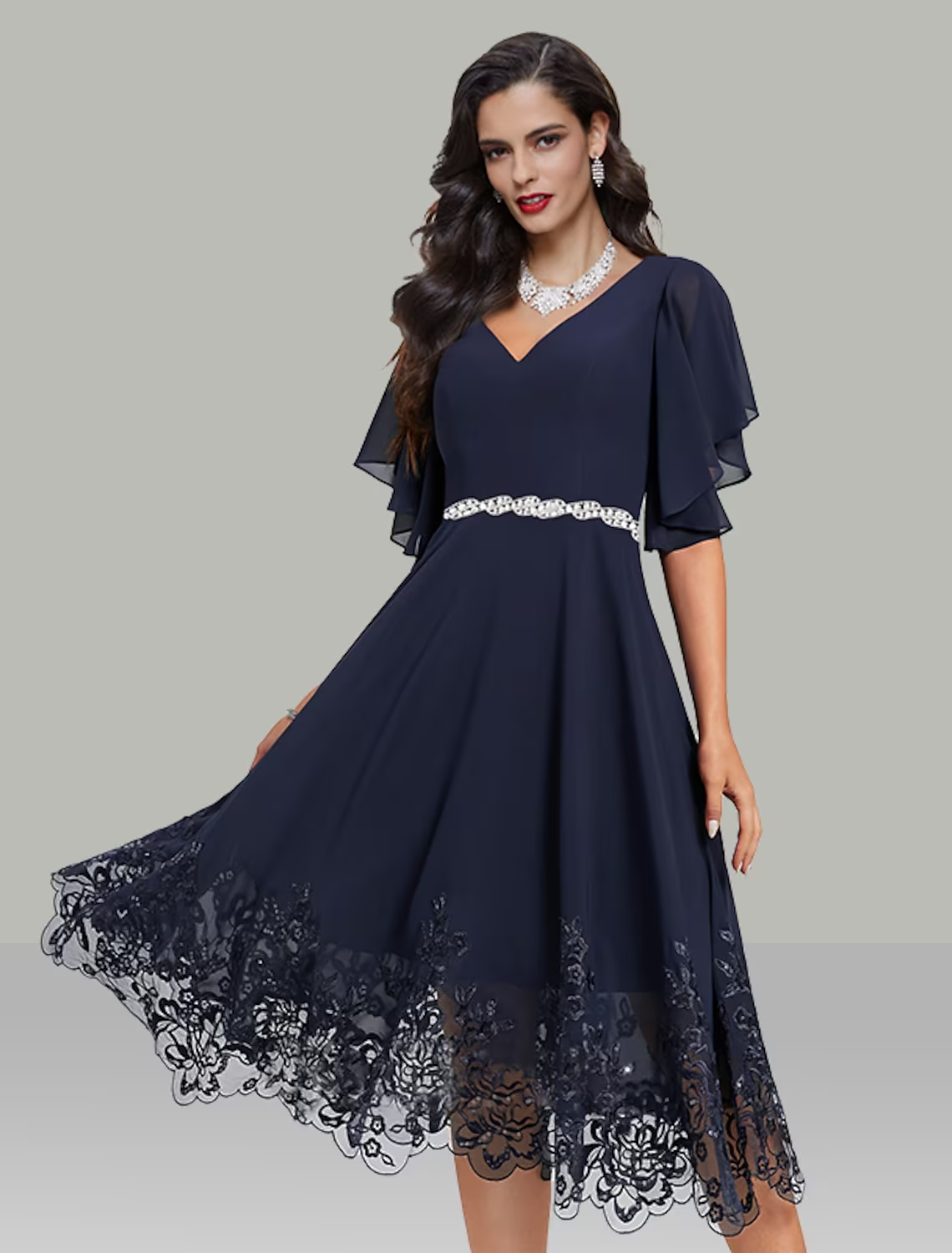 Elegant A-line tea length chiffon dress with V-neck and short sleeves, featuring rhinestone and glitter embroidery.