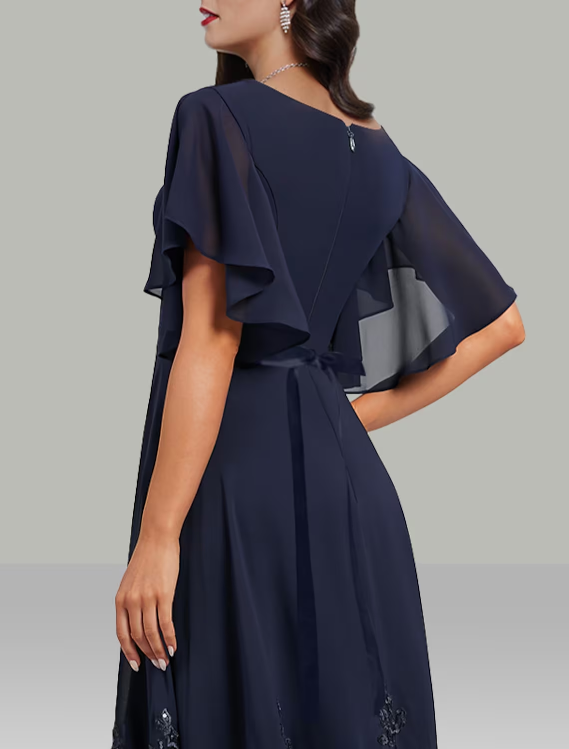 Back view of the A-line tea length dress, highlighting the flow of the chiffon fabric.
