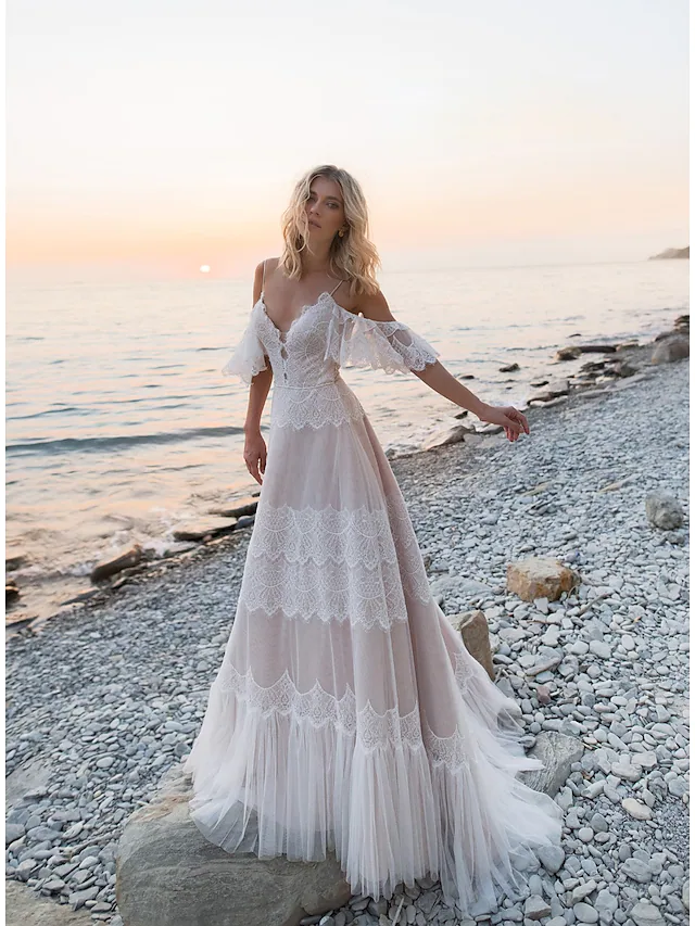 Front view of an A-line V-neck wedding dress with lace and tulle, short sleeves, and illusion details.
