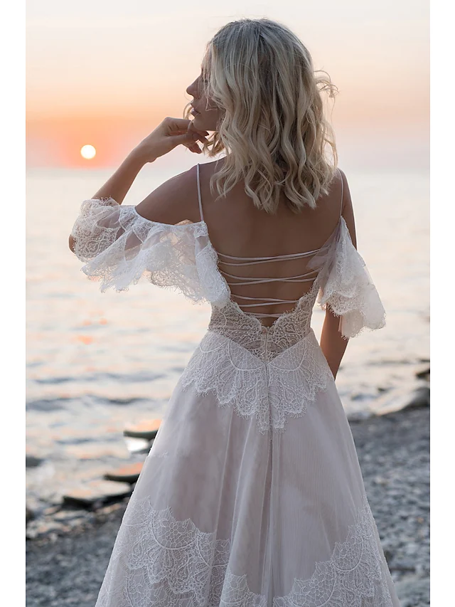 Back view of the A-line wedding dress, highlighting the backless design and lace details.