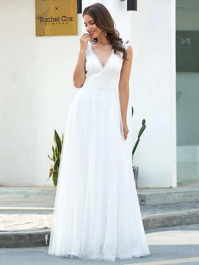 Side view of floor-length lace and tulle wedding gown.