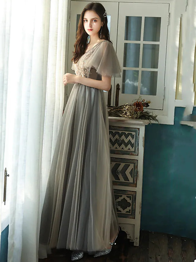 Close-up of the V-neckline and short sleeve detail with beading and sequins.