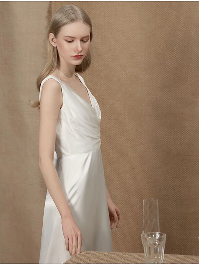 Close-up of ruched detail on a simple vintage charmeuse wedding gown.