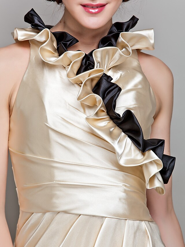Close-up of ruffled 3/4 sleeve and stretch satin fabric on formal dress.