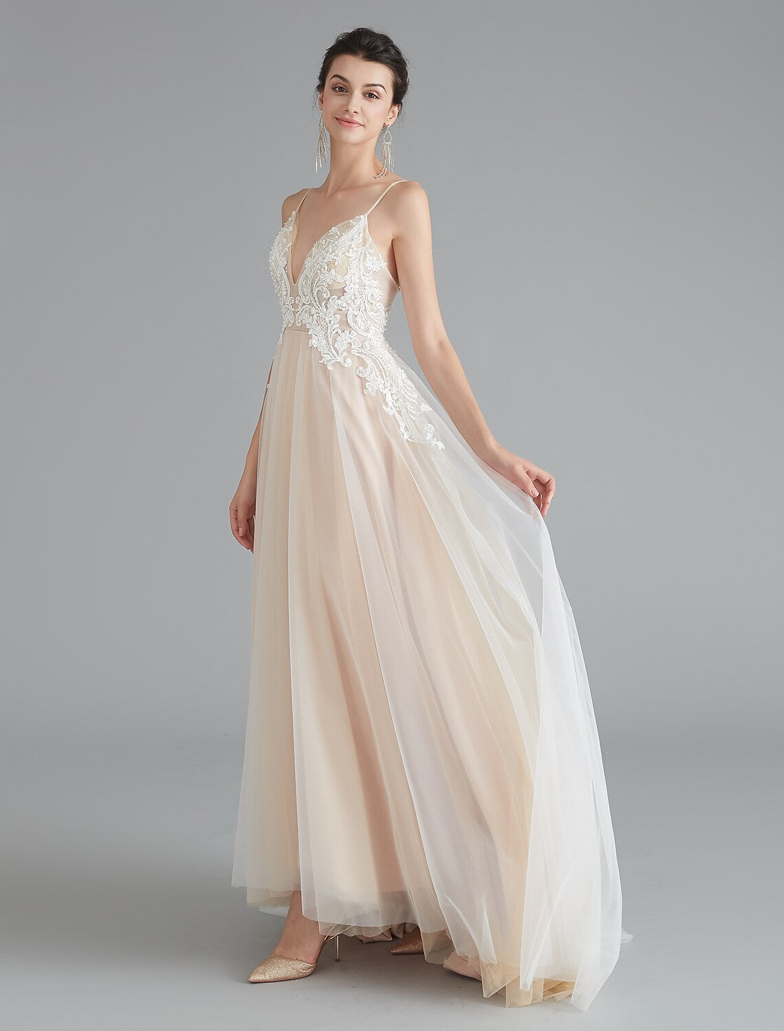 Back view of A-line prom dress showing intricate lace and sweep train.