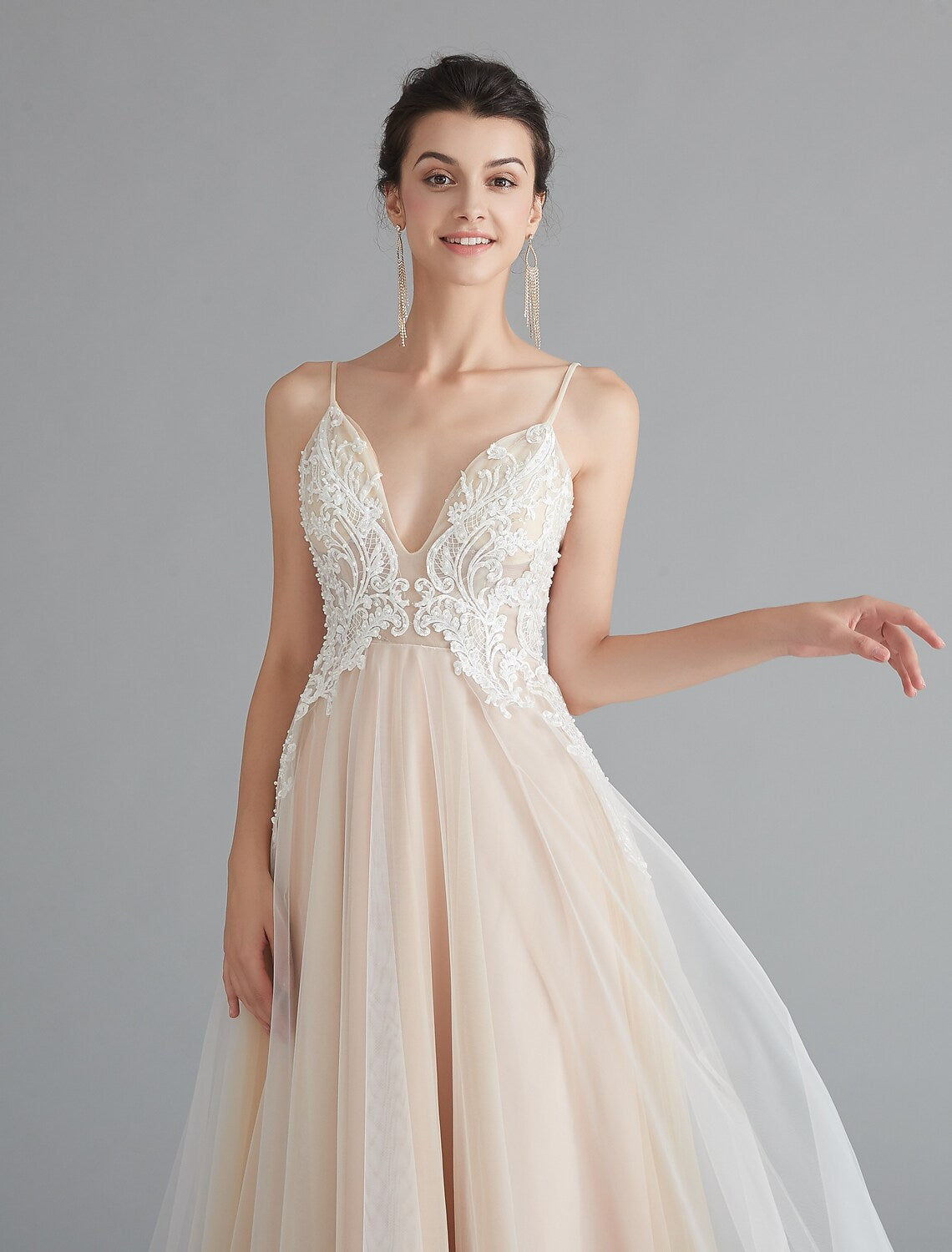 Close-up of intricate lace and beading on a formal dress.