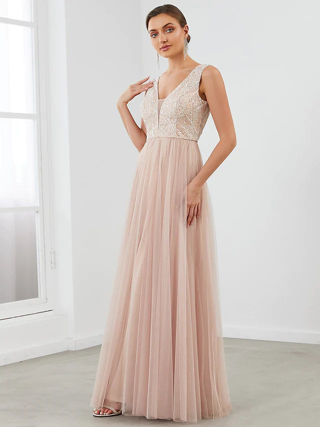 Full length view of a woman wearing an A-line V-neck evening gown.