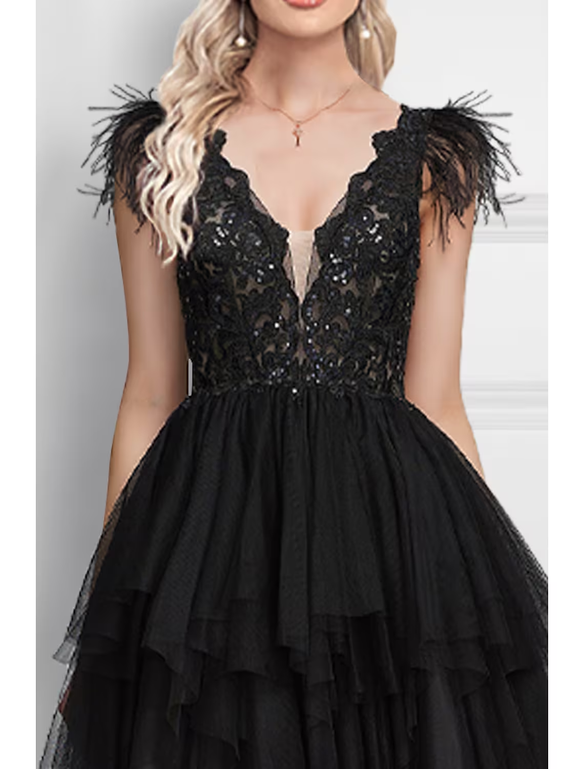 Back view of an elegant black V-neck prom dress with a flowing tulle skirt.