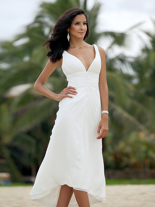 Model wearing the flowing asymmetrical chiffon wedding dress.