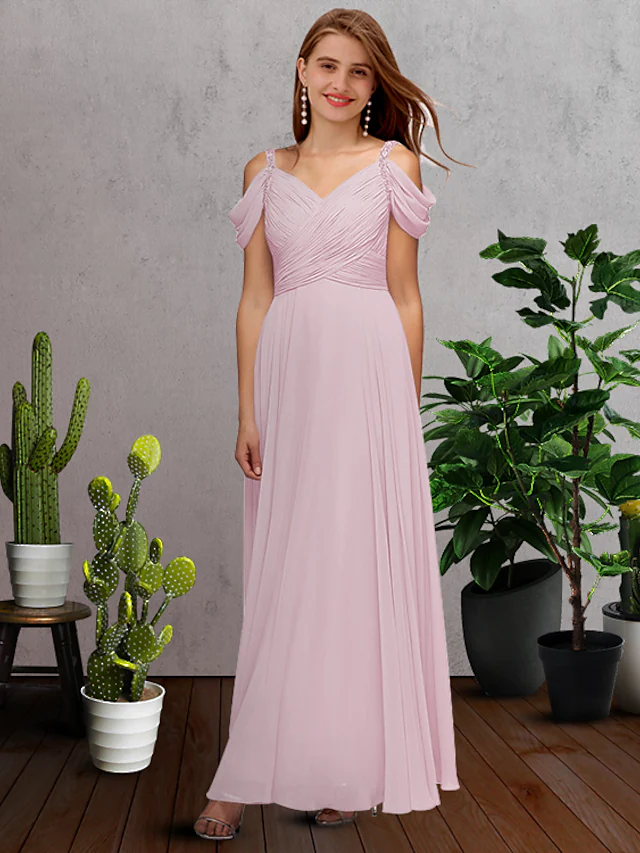 A-line V-neck chiffon bridesmaid dress with spaghetti straps and pleats.