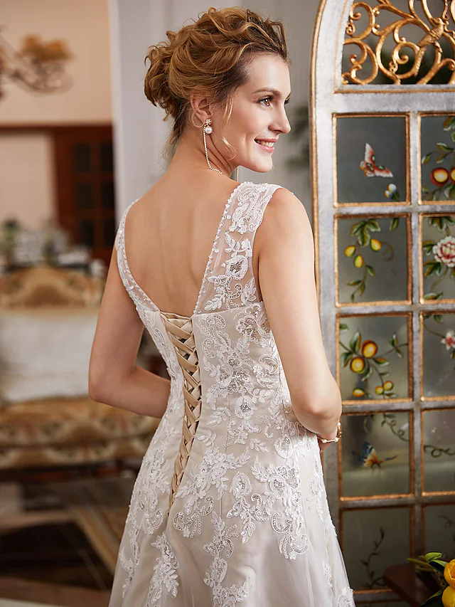 Detail shot of the romantic illusion lace and beading appliques on the wedding gown.