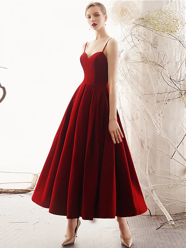 Side view of the A-line velvet dress, showing sleek pleats and ankle length.