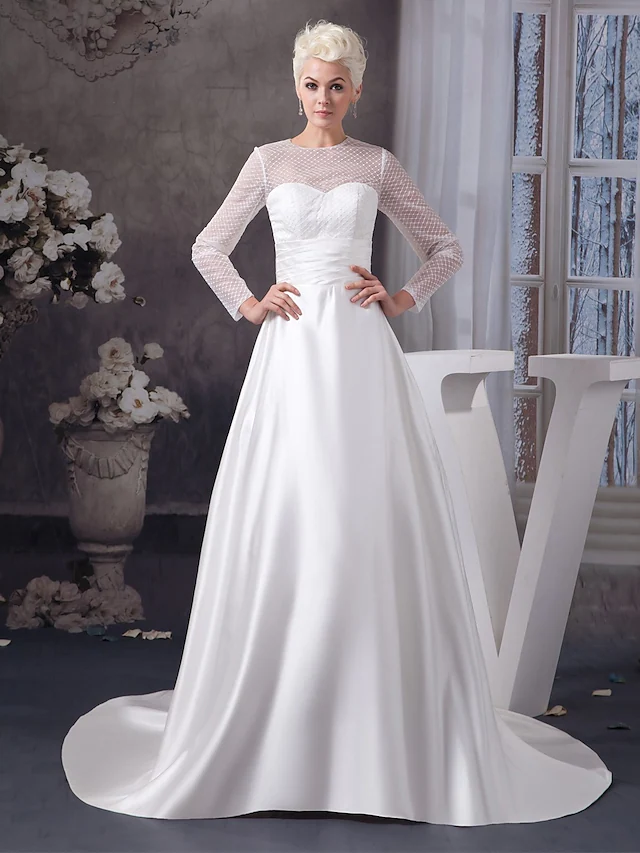 Elegant A-Line wedding dress with jewel neck and illusion sleeves.