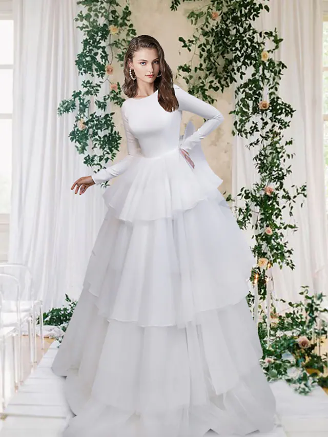 Elegant A-line wedding dress with jewel neck, long sleeves, and cascading ruffles.
