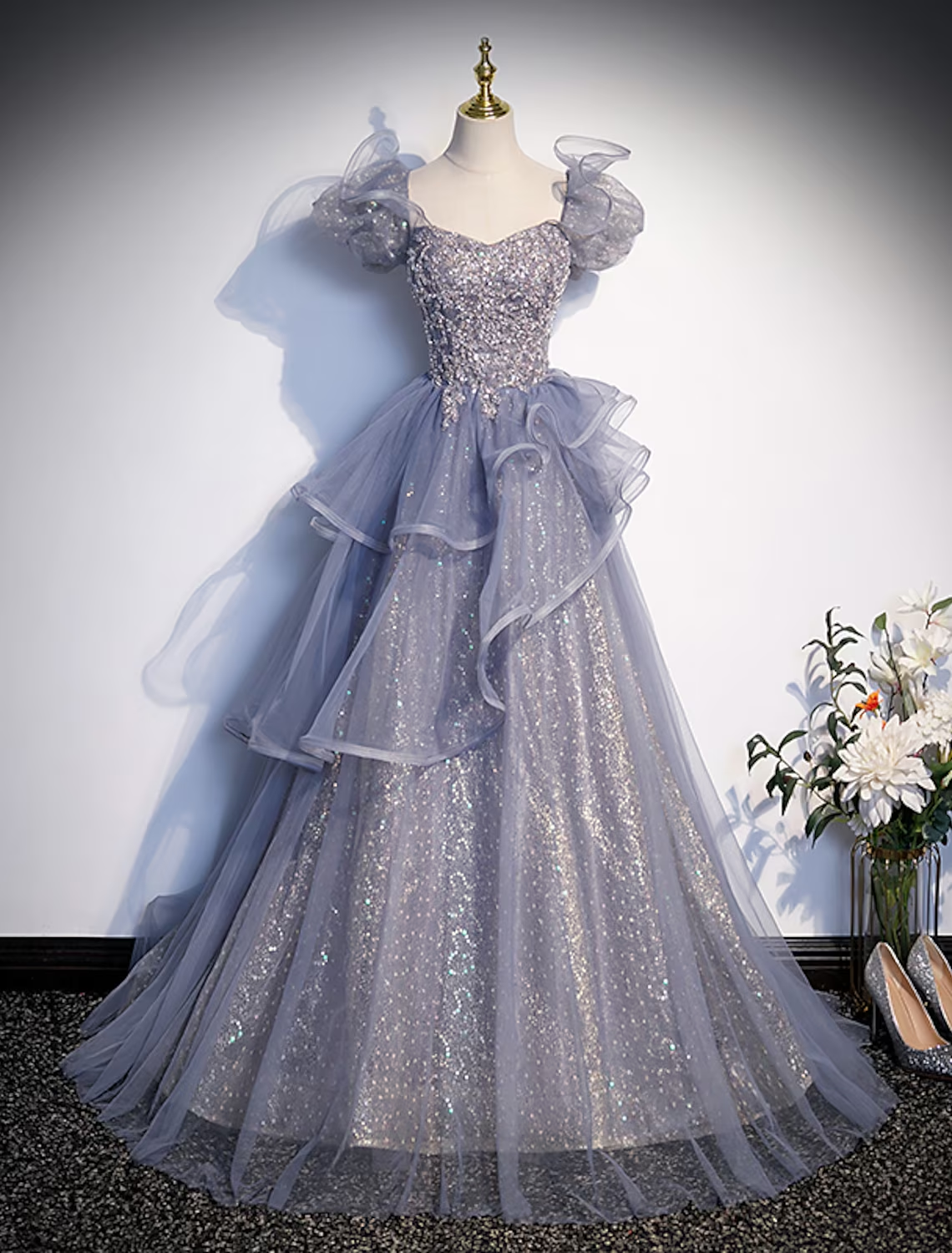 Elegant aqua ball gown Quinceanera dress with square neck and short sleeves.