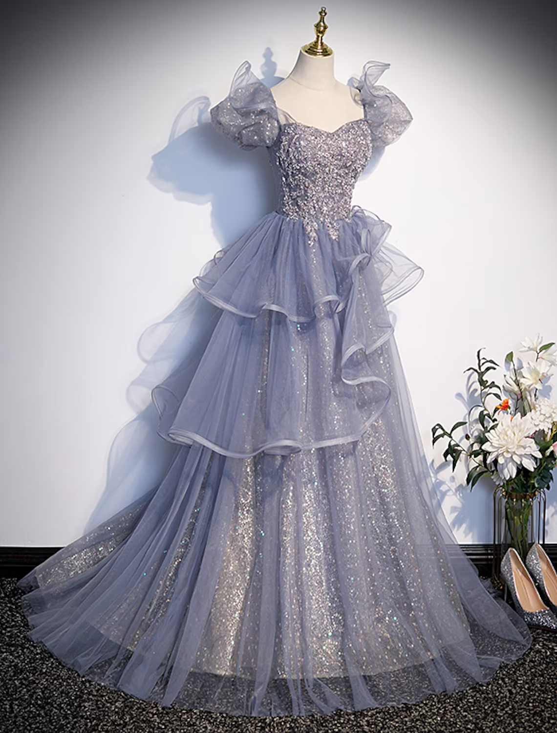 Aqua Quinceanera ball gown featuring ruffled tulle and crystal embellishments.