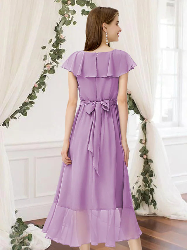 Model wearing an elegant A-Line V-neck chiffon bridesmaid dress with ruffles and asymmetrical hem, back view.
