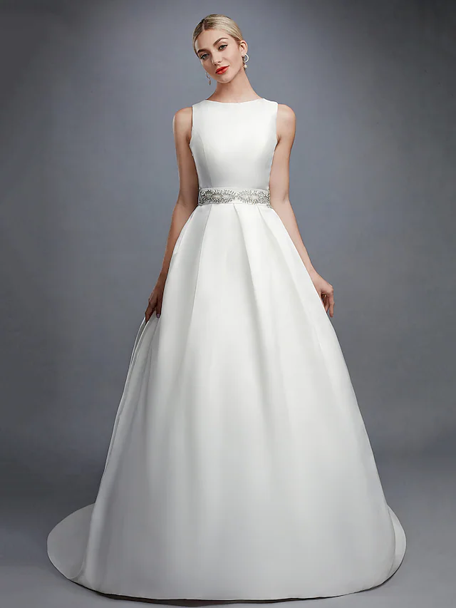 Front view of white ball gown wedding dress with bateau neck and lace.