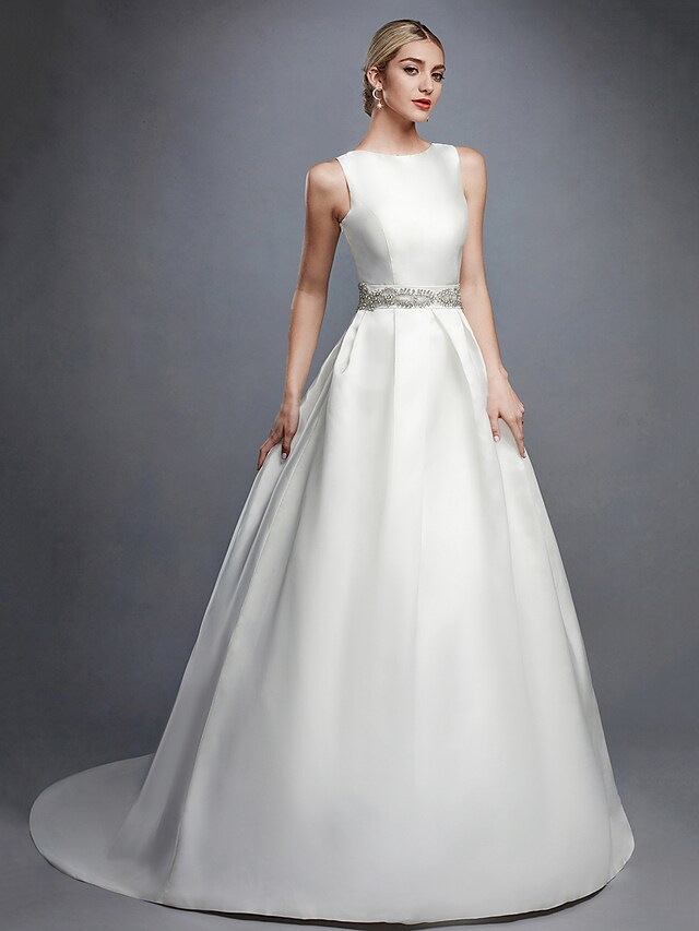 Back view of white ball gown wedding dress with lace sash and court train.