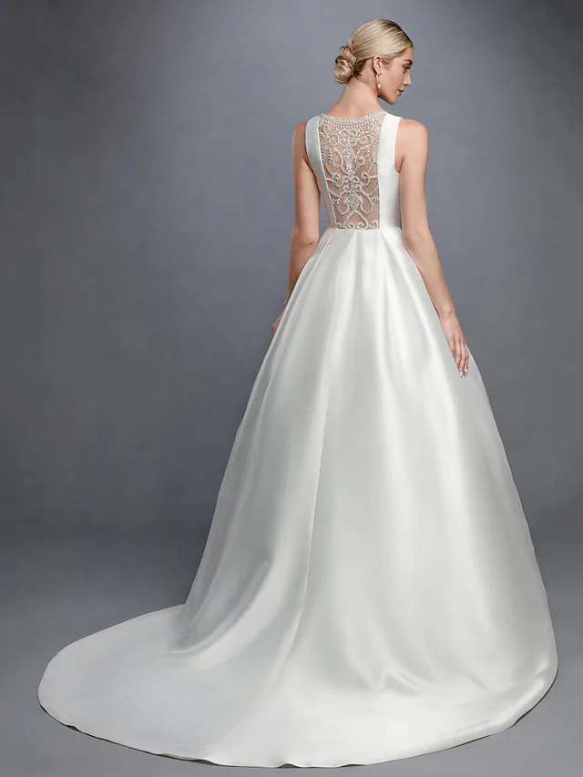 Detailed view of satin fabric and ribbon on wedding dress.