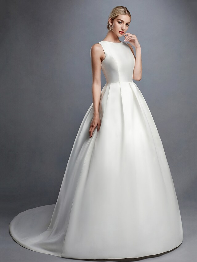 Full length view of white formal wedding dress with bateau neckline.