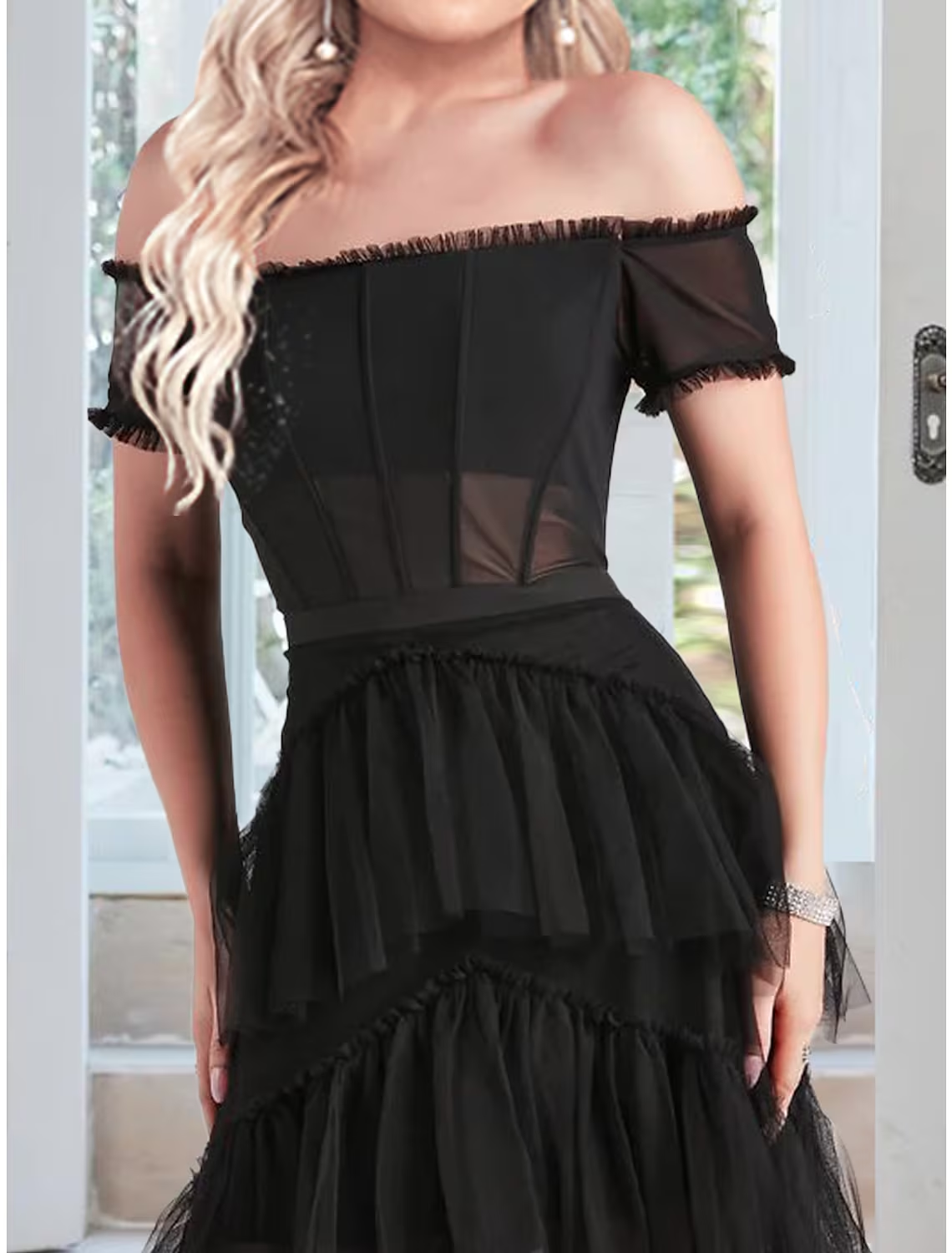 Side view of the floor-length off-shoulder prom dress.