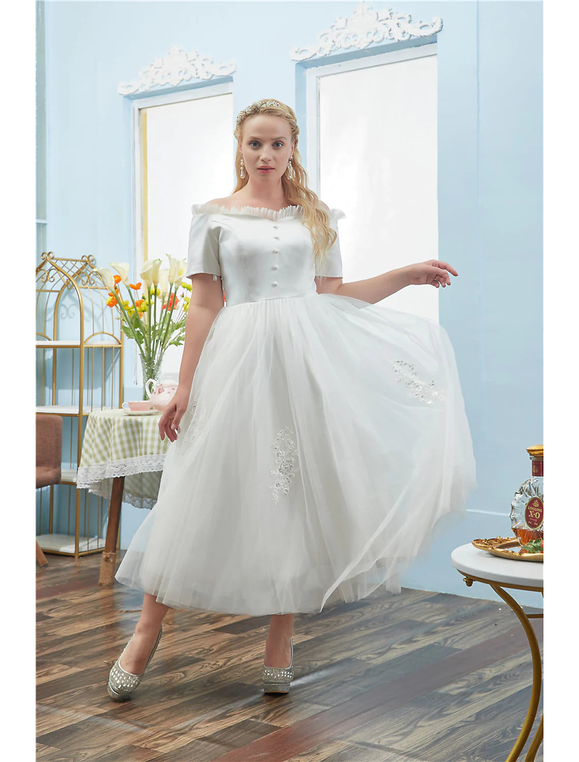 Full view of a tea length plus size off-shoulder cocktail dress in tulle.