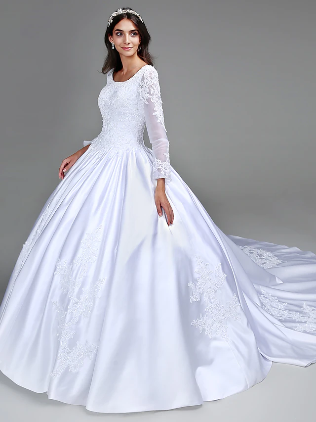 Side view of the long sleeve ball gown wedding dress with intricate beading.