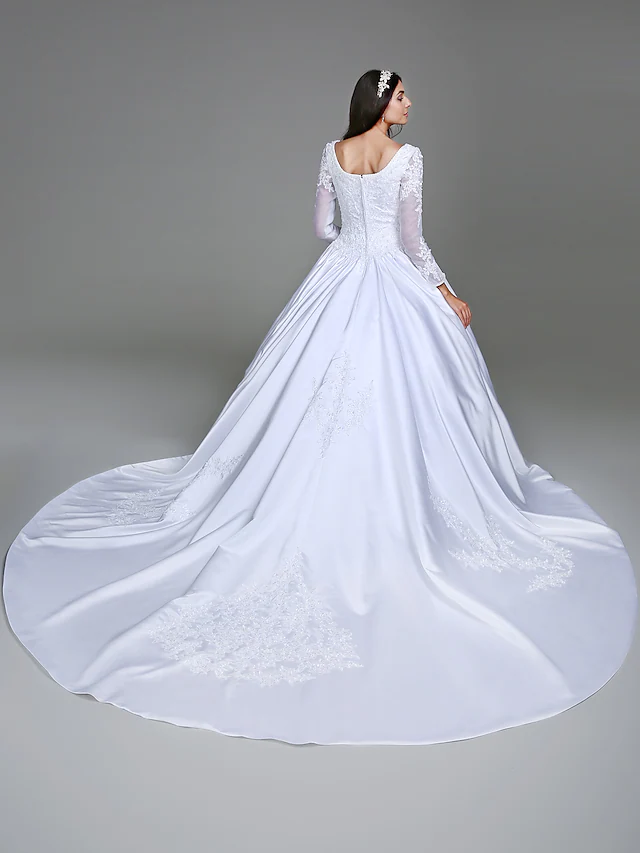 Detail of the see-through long sleeves and beading appliques on the bridal gown.