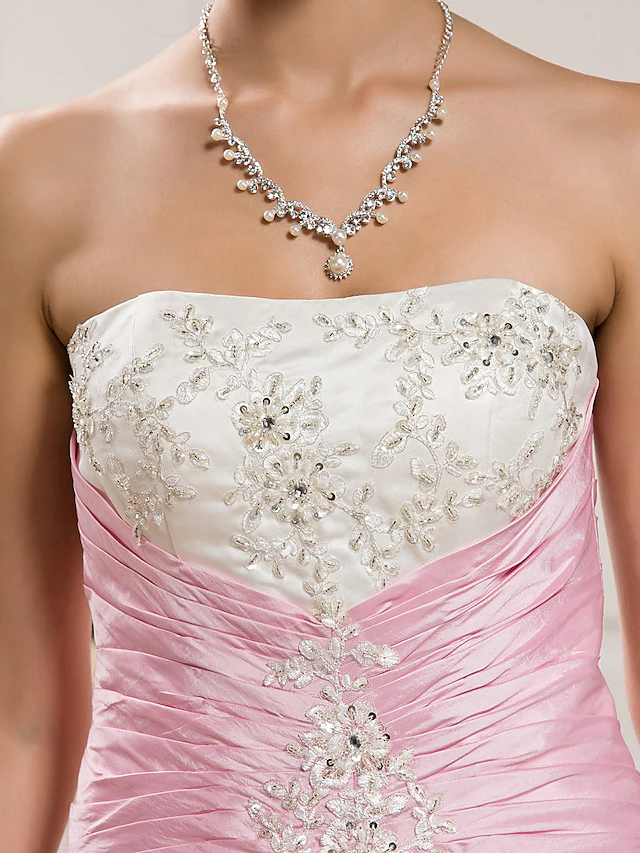 Side view of a bride wearing a strapless organza taffeta ball gown.